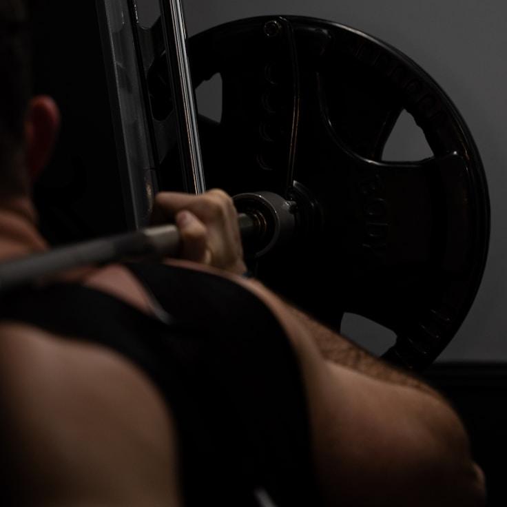 Interior of a professional gym with weight training equipment and mirrors